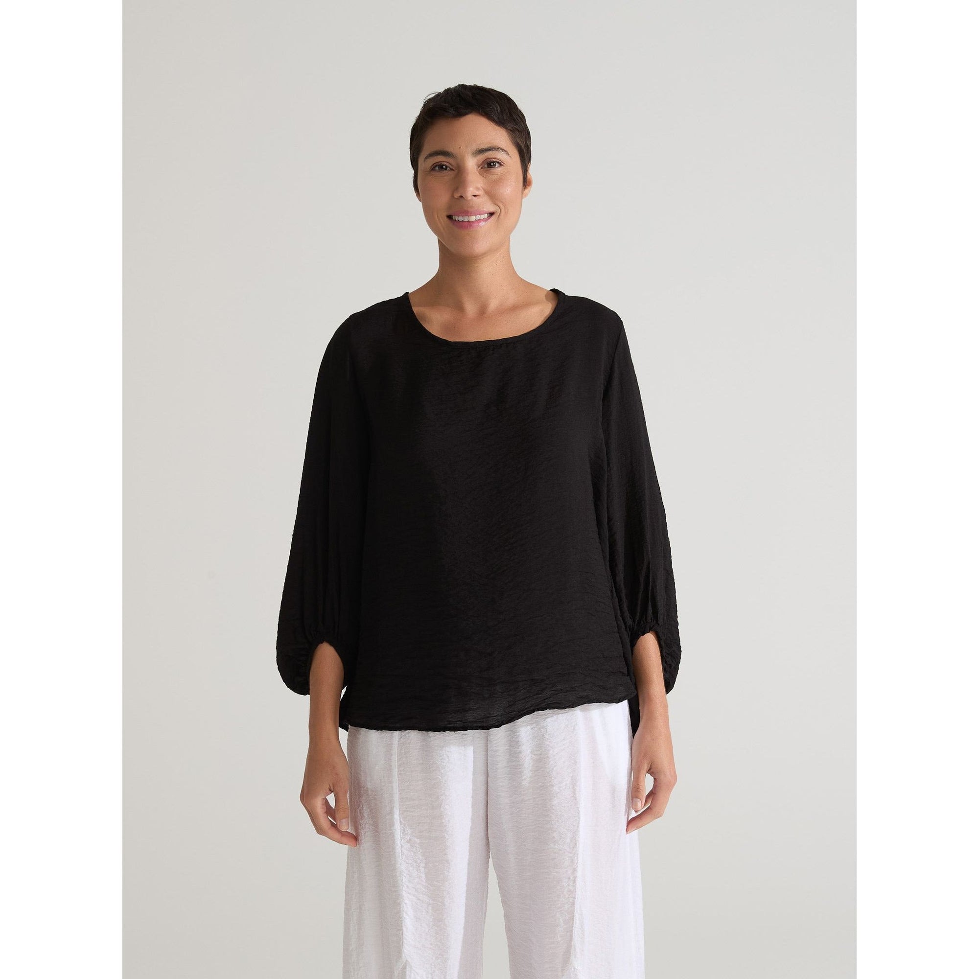 Light-colored balloon sleeve top by Cutloose with dramatic puffed sleeves and a relaxed fit.