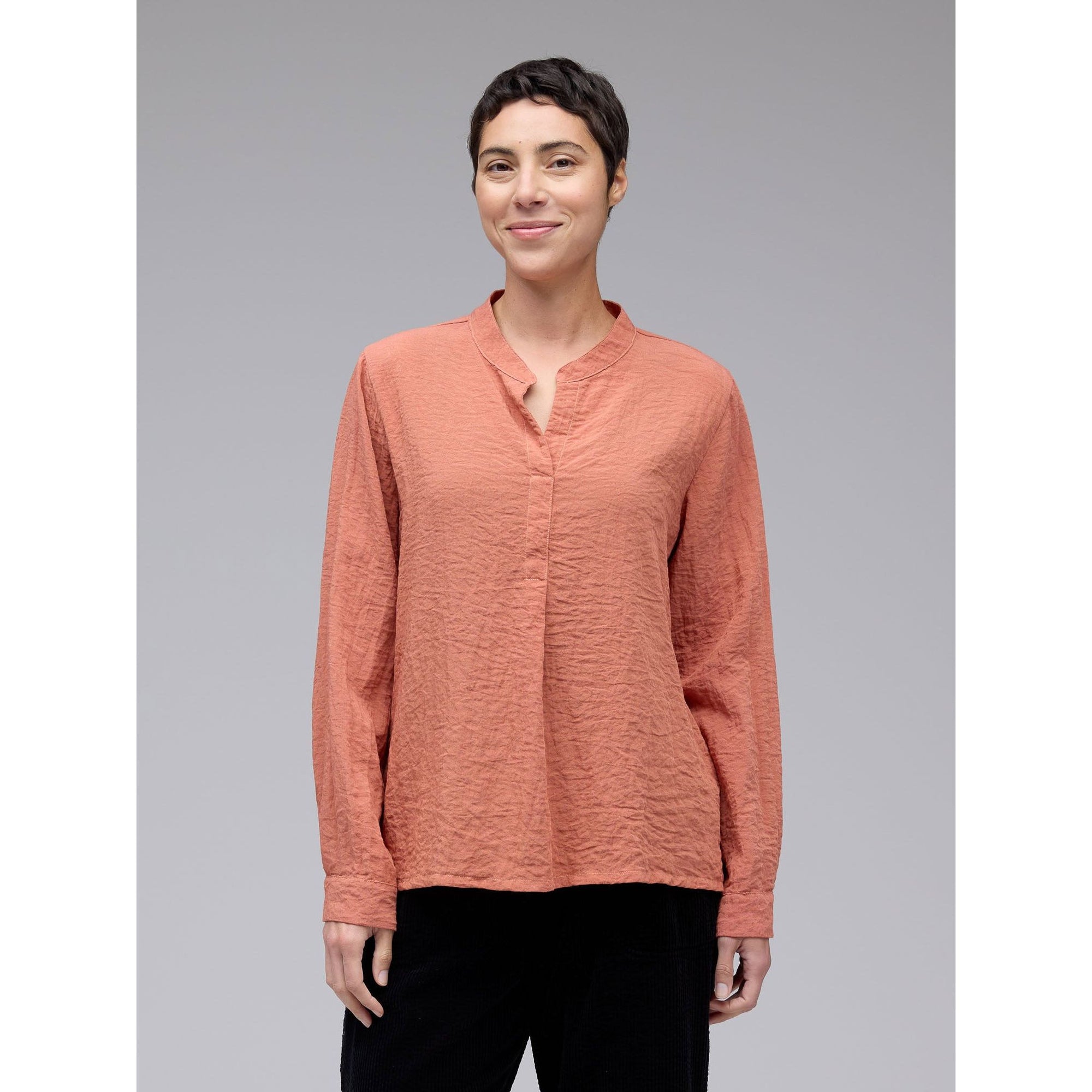 Light orange front pleat top by Cutloose, featuring a relaxed fit and stylish design, shown on a mannequin.