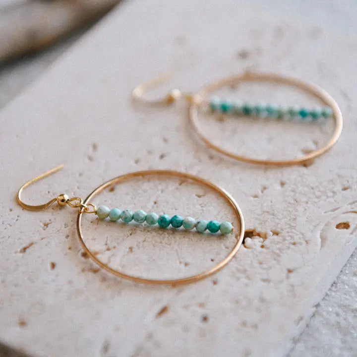 Gold-plated drop hoop earring with gemstone accents from Cecelia Designs Jewelry, showcasing intricate jewelry craftsmanship.