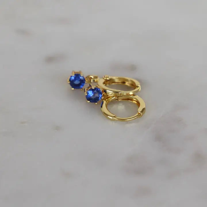 Huggies Round Birthstone jewelry by Katie Waltman featuring a round gemstone pendant on a delicate chain.
