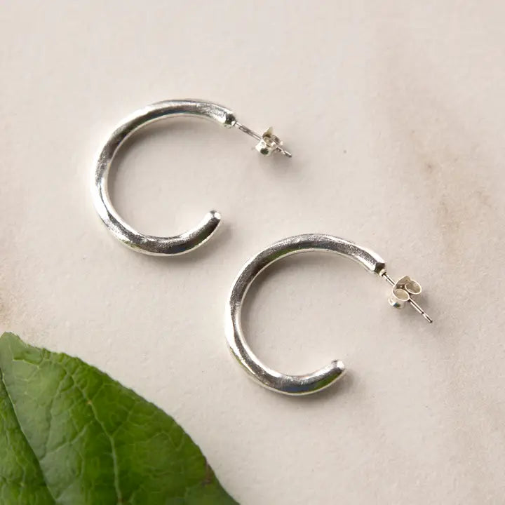 Stowaway Imani hand-sculpted hoop post earrings made of jewelry, featuring a unique artistic design and polished finish.