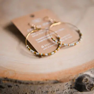 Boho beaded hoop earrings by Cecelia Designs Jewelry featuring colorful beads and gold-tone hoop design.