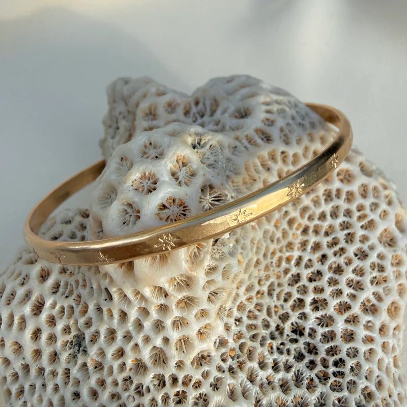 In Situ Sea of Stars bangle bracelet featuring a delicate gold-filled design with star motifs, perfect for elegant jewelry collection