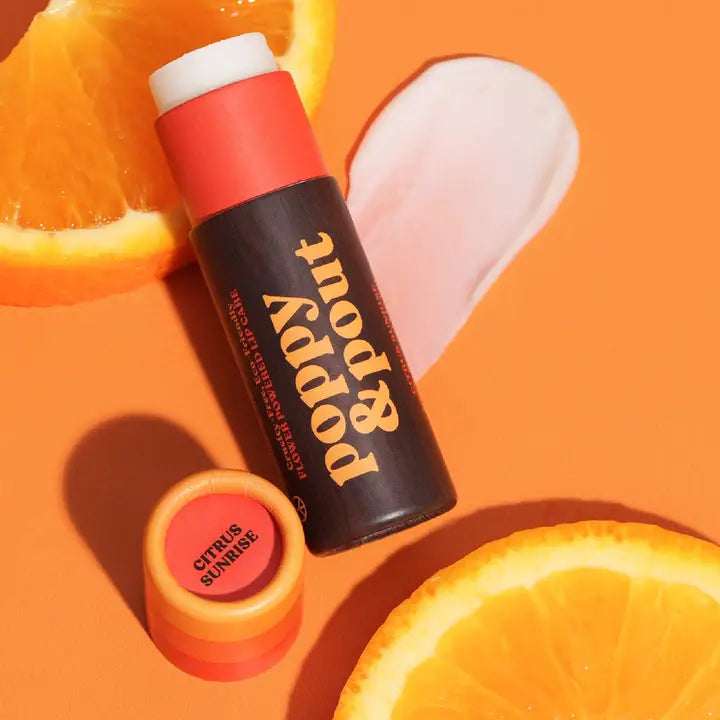 Natural lip balm by Poppy & Pout in a clear container, showcasing the smooth, nourishing balm inside.
