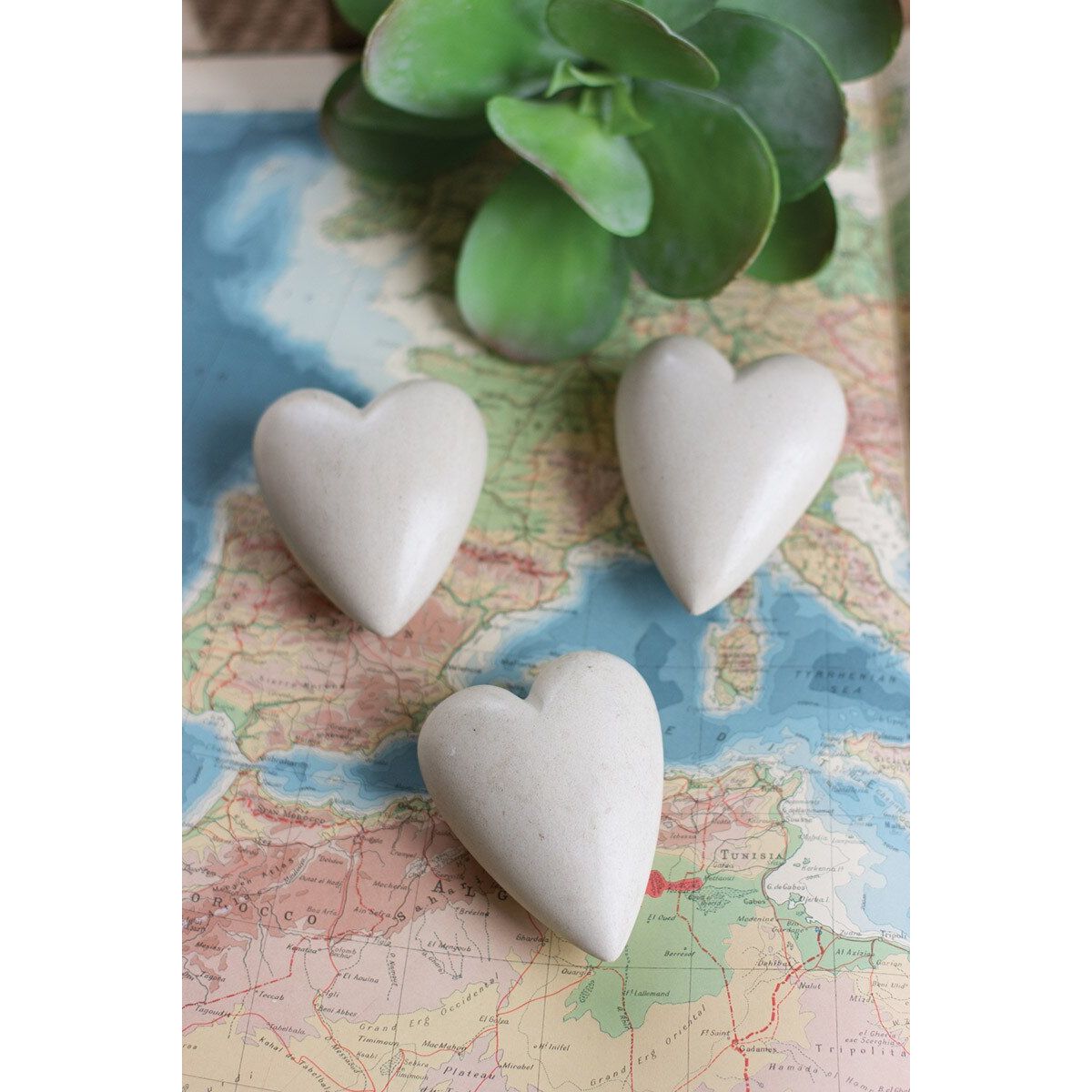 Hand-carved stone hearts by Kalalou, showcasing smooth, natural stone with detailed heart shapes on a neutral background.