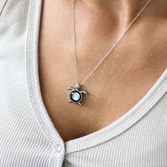 Moonglow sea turtle necklace featuring a detailed turtle pendant on a delicate chain, showcasing ocean-inspired jewelry design.