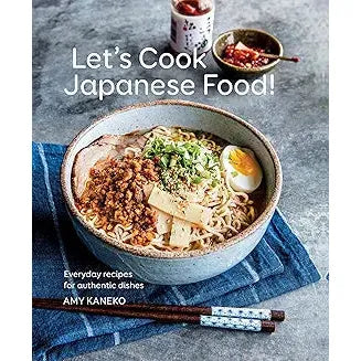 Book cover for "Let's Cook Japanese Food!" featuring traditional Japanese dishes and authentic recipes from a popular cooking guide.