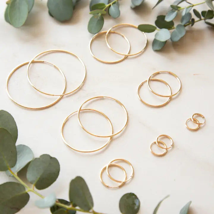 Stowaway gold endless hoops jewelry with sleek, circular design perfect for everyday wear.