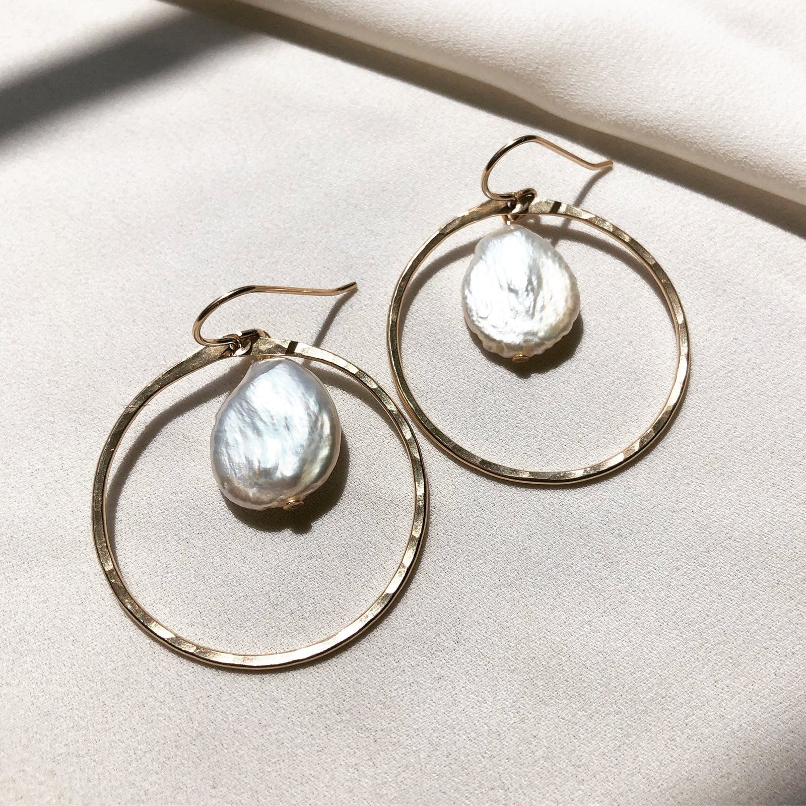 In Situ Wailua GF earrings featuring elegant gold jewelry with intricate design details on a white background.