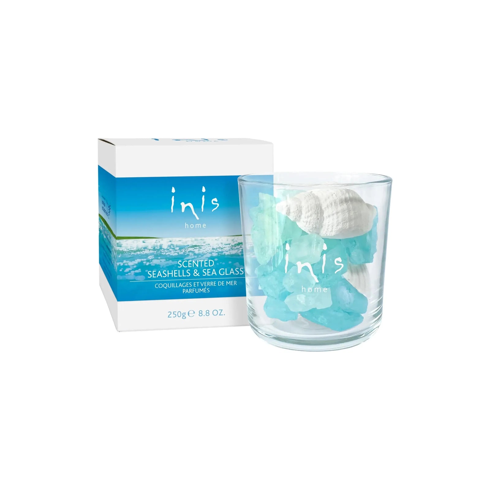 Inis Fragrance of Ireland home scented cologne with seashells and sea glass, showcasing the elegant bottle and natural decor elements.