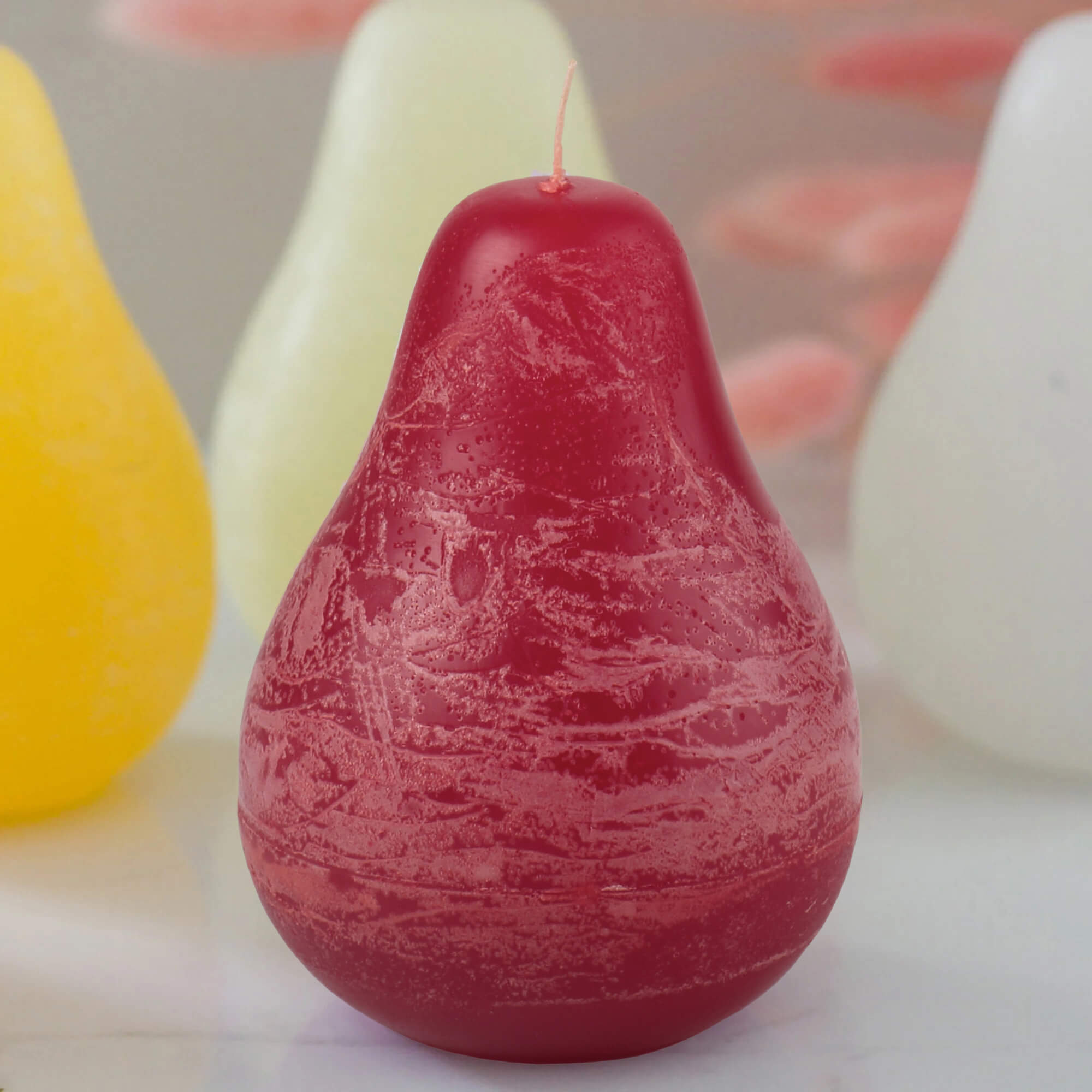 Vance Kittira Petite Pear Candle with cranberry scent, showcasing a small decorative candle in a clear glass holder.
